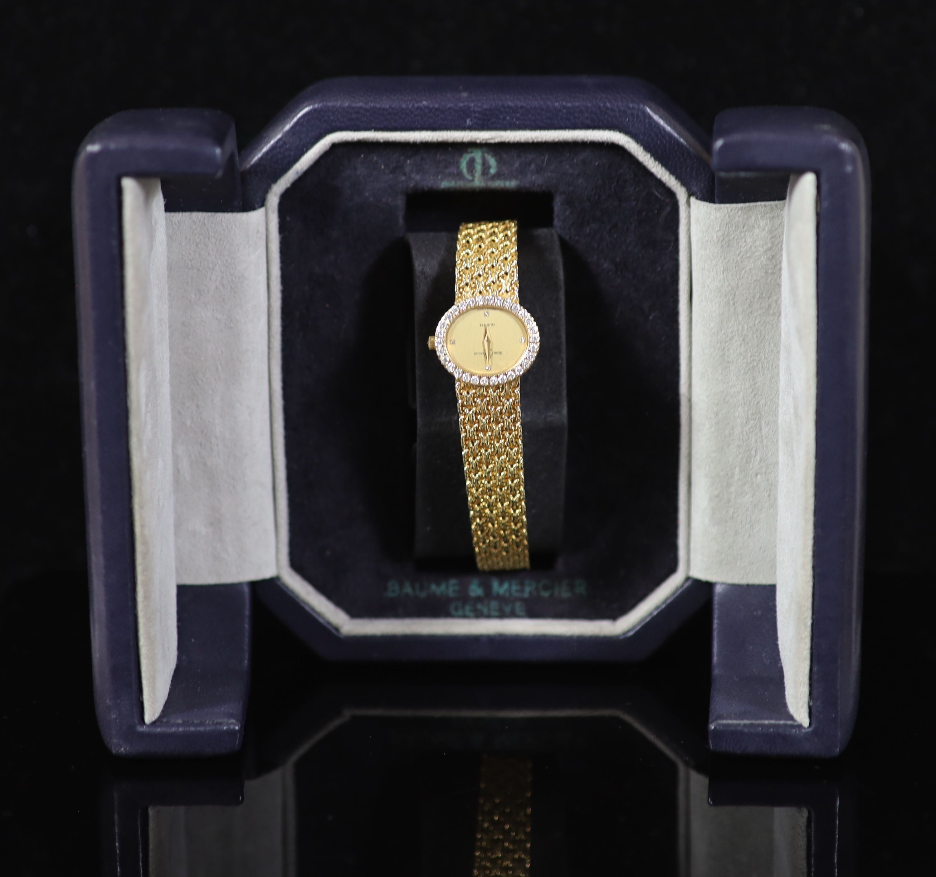 A lady's 18ct gold Baume & Mercier quartz oval dress bracelet wrist watch, with diamond set bezel